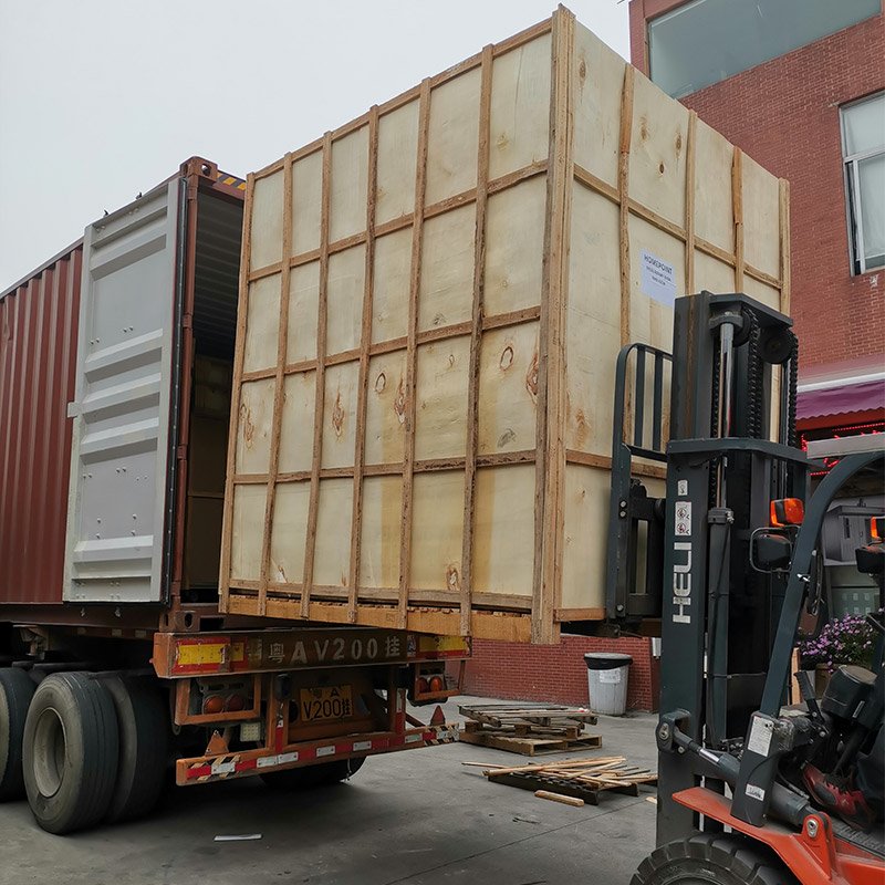Wooden-crated commercial oven being loaded for export shipment